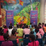 Children listen attentively to Thelma Perkins at Tobago's Bocas Lit Storytelling Caravan.