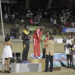 Andwuelle Wright, centre, stands atop the podium after his gold medal-winning endeavour in the Boys under-20 long jump.