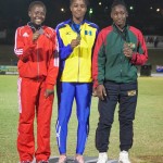 Asha James, left, stands proudly after winning Girls under-18 silver in the javelin throw event. She launched the spear 45.12 metres for her best throw. Photos courtesy THA Info Dept.